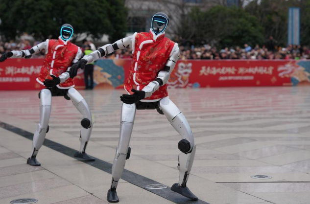 This photo taken on Feb. 28, 2026 shows humanoid robots of Unitree Robotics dancing at a square in Tonglu County, east China's Zhejiang Province. (Xinhua/Huang Zongzhi)