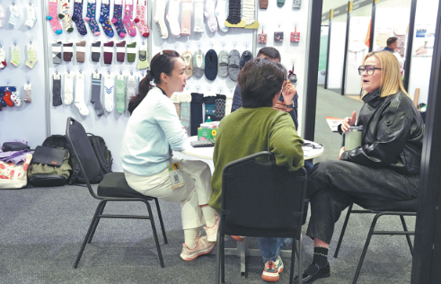 People visit the booth of a Chinese exhibitor at the China Premium Textile South Africa and Allfashion Sourcing 2026 expo in Cape Town, South Africa, on July 14. WANG LEI/XINHUA
